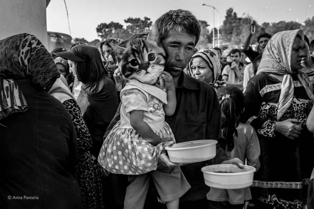 (no consent)An Afghan father with his daughter get a portion of rice, lentils and break from the common meal in Moria camp. Lesvos Sept 7, 2015.